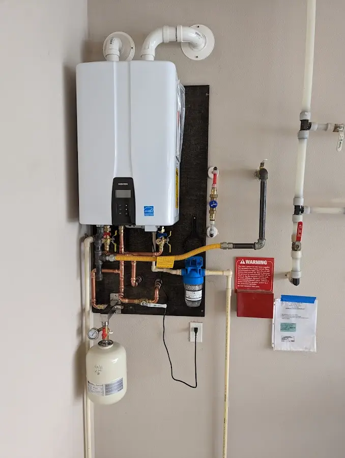 Professional plumber installing copper piping in a West Pittston home